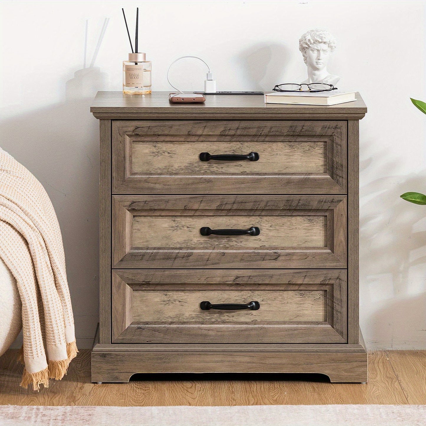Wooden Bedside Table Featuring a Charging Station, Equipped with Three Drawers And Metal Handles, Perfect for Bedroom Storage.