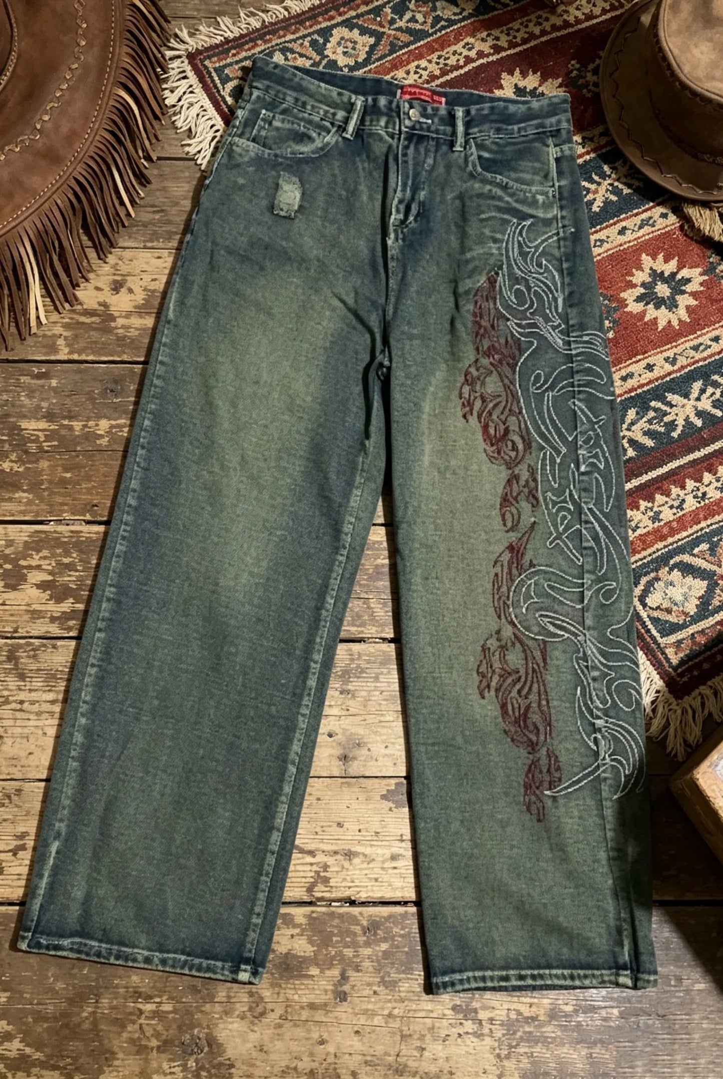 Vintage-style high-waisted wide-leg jeans with side print, distressed finish, loose straight leg, casual and stylish.