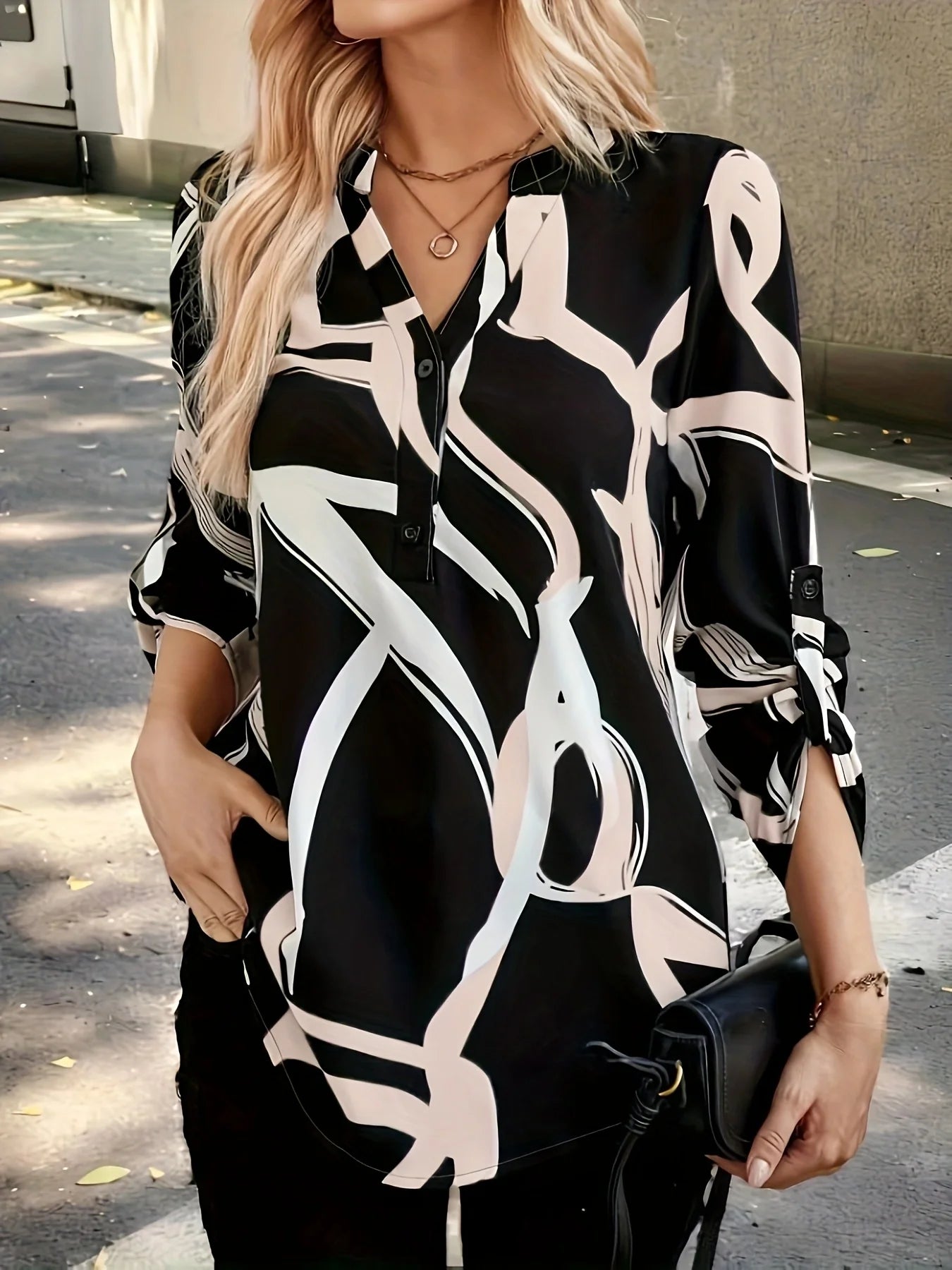 Plus size women's black and white abstract line half-open shirt; stand collar half-buttoned with roll-up three-quarter sleeves and pockets; drape-effect commuting printed top