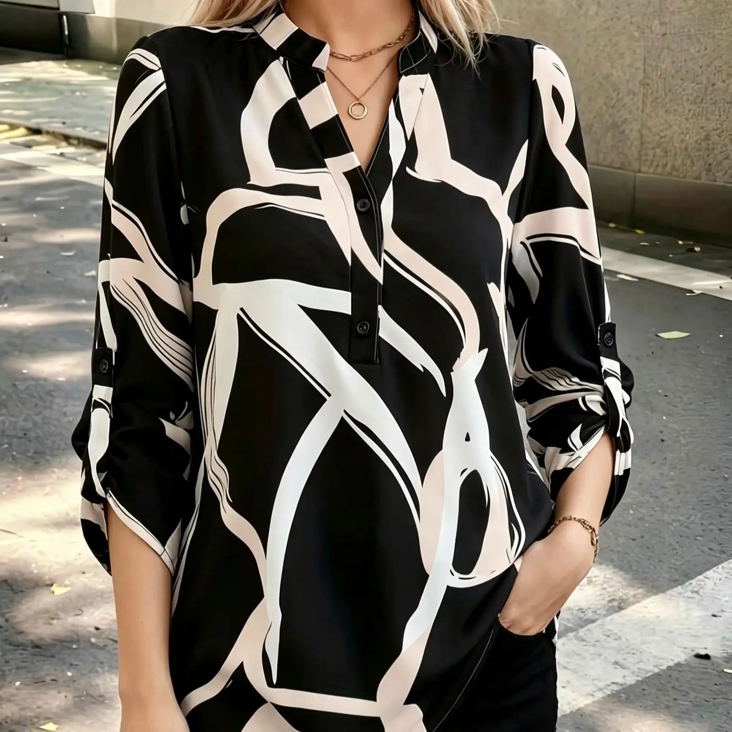 Plus size women's black and white abstract line half-open shirt; stand collar half-buttoned with roll-up three-quarter sleeves and pockets; drape-effect commuting printed top