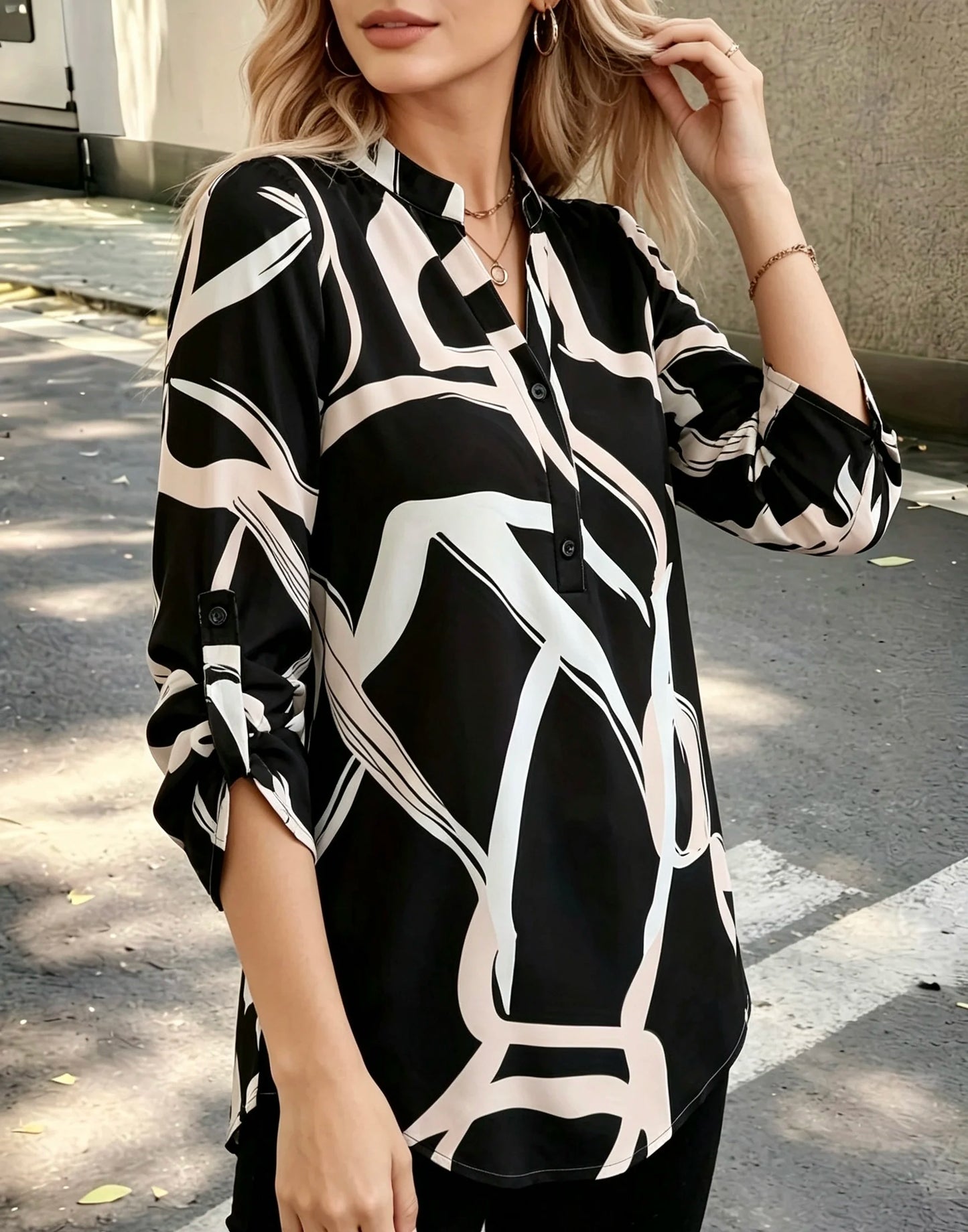 Plus size women's black and white abstract line half-open shirt; stand collar half-buttoned with roll-up three-quarter sleeves and pockets; drape-effect commuting printed top